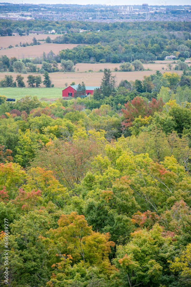 red barn in the distance in a fall countryside landscape