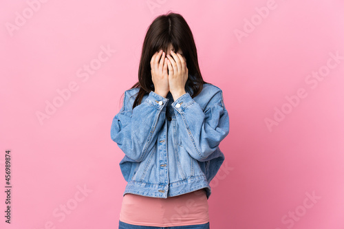 Young Ukrainian woman isolated on pink background with tired and sick expression © luismolinero