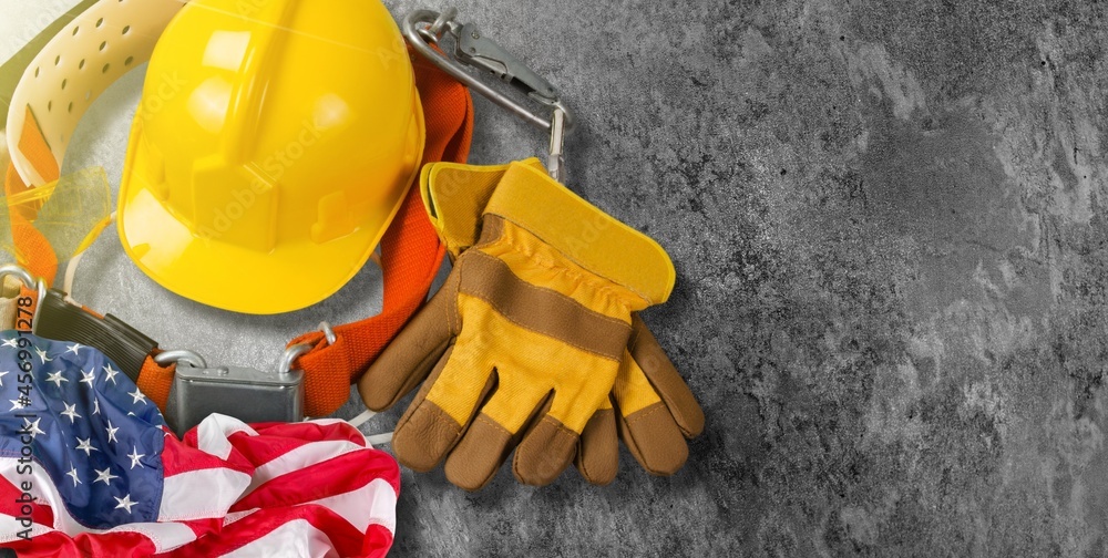 Happy Labor day concept. American flag with different construction tools Happy Labor day concept. American flag with different construction tools
