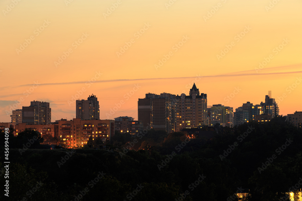 Panorama of city buildings at sunrise or sunset, the landscape of the big city with buildings of different heights