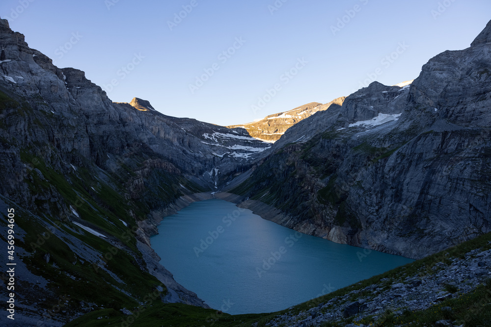 Wonderful sunrise over an alpine lake called Limmerensee in Switzerland. Just an amazing view in the Swiss alps. You see the rocks shined by the sun. Wonderful sunrise over an alpine lake called Limmerensee in Switzerland. Just an amazing view in the Swiss alps. You see the rocks shined by the sun.