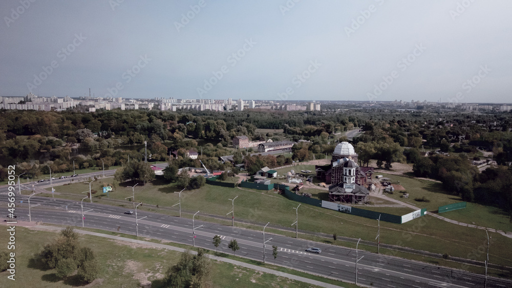 Construction of a church in the city park. Close to the city block. Aerial photography. Construction of a church in the city park. Close to the city block. Aerial photography.