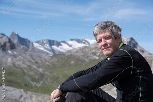 Portrait of a man hiking in the mountains in summer
