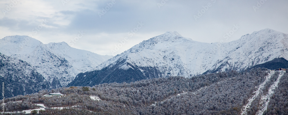 Snow-covered forest in autumn at a snowy mountain peak