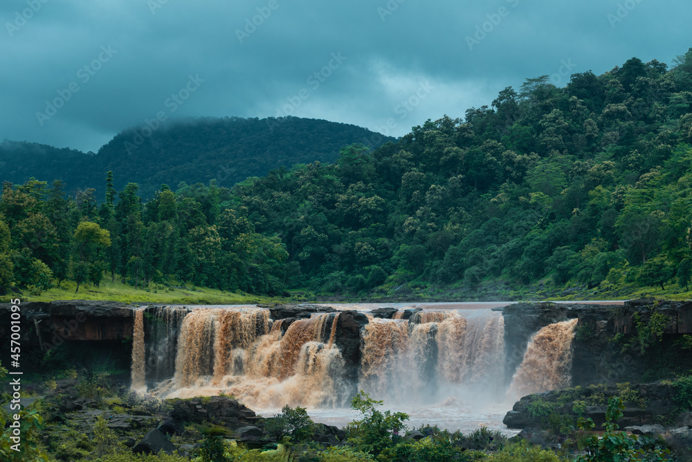 Vertical image of Gira waterfall and green mountain at Waghai, Saputara, Gujarat, India. Beautiful natural landscape