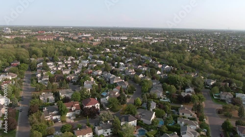Aerial jib shot showing houses in beautiful residential neighbourhood in Montreal, Quebec, Canada, North America. Property, housing and real estate concept, summer season.