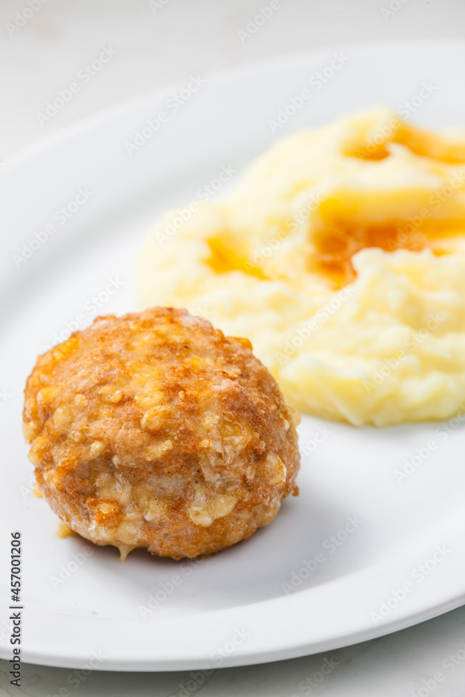 meat ball with cheese served with mashed potatoes