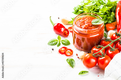 Tomato sauce. Traditional italian tomato sauce with fresh tomatoes, herbs and spices at white kitchen table.