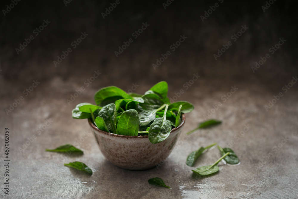 Leaves of fresh baby spinach in a Bowl. Leaves of fresh baby spinach in a Bowl.
