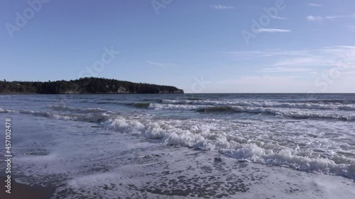 Foaming Tide on a Wavy Beach