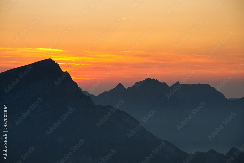 mountain silhouette at night during colorful sunset time in the swiss alps mountains