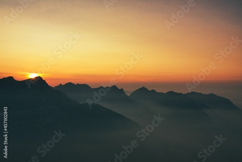 mountain silhouette at night during colorful sunset time in the swiss alps mountains
