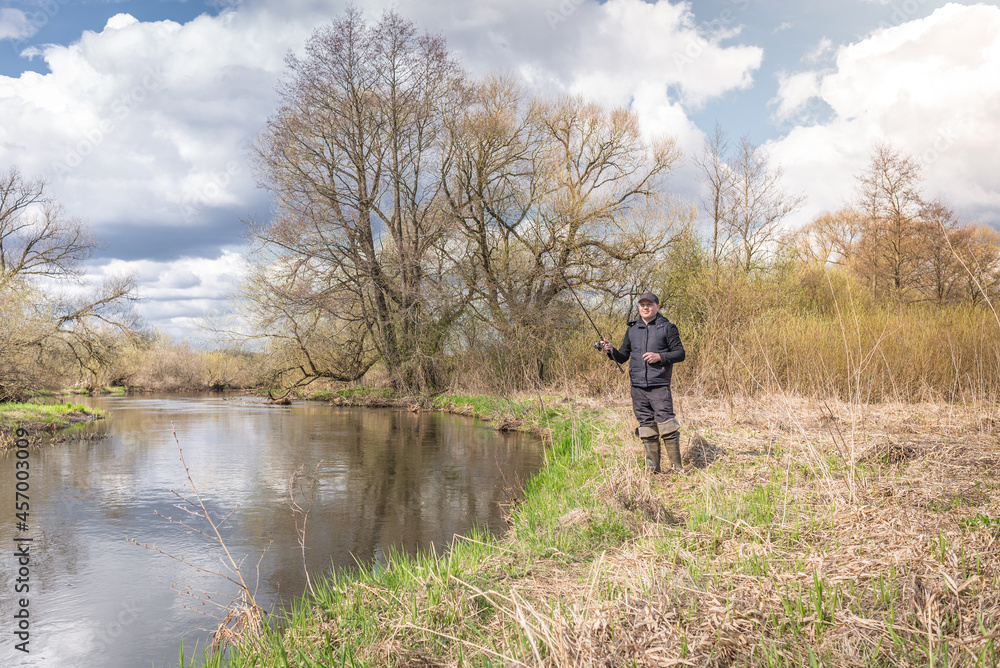 Fisherman throws a spinning rod. Fisherman throws a spinning rod.