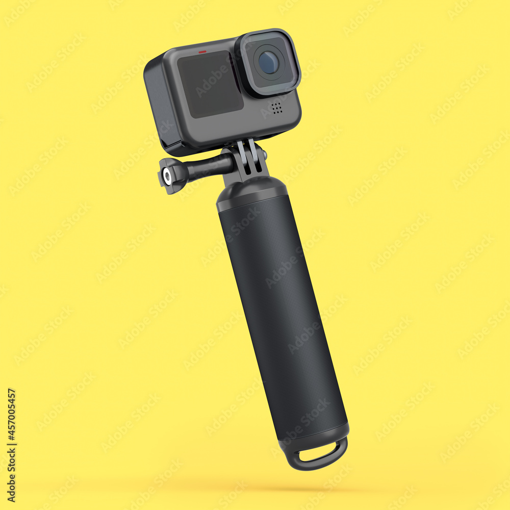 Photo and video lightweight black action camera with monopod on yellow Photo and video lightweight black action camera with monopod on yellow