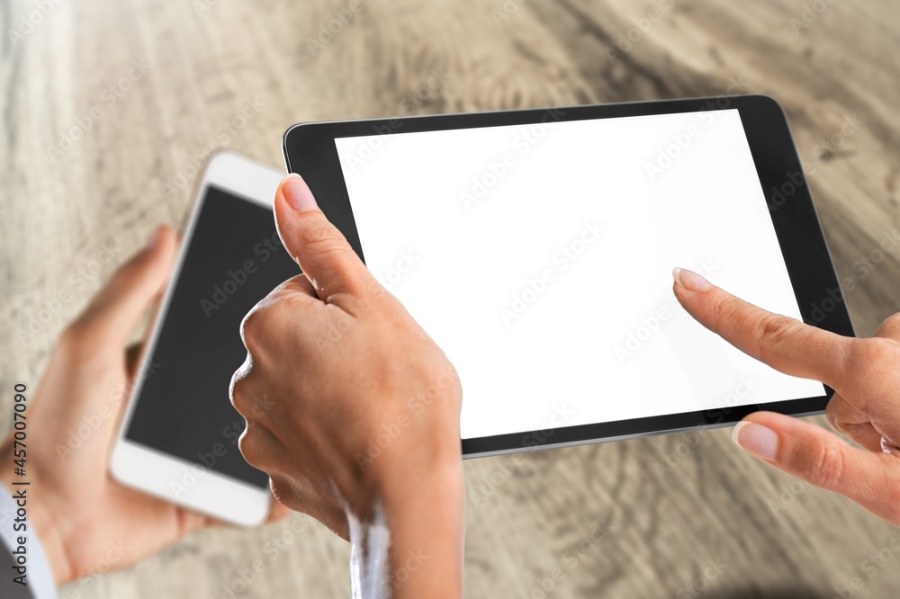 Two modern smartphones with blank screens in human hands Two modern smartphones with blank screens in human hands