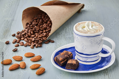 Photography A cup of coffee with whipped cream and coffee beans
