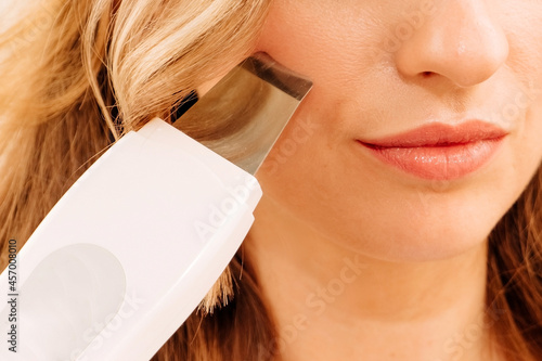 portrait of a girl close-up. woman with clean beautiful skin, face scrubber, horizontal image. photo