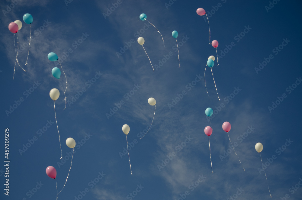 Helium balloons fly in the air. Blue sky Stock Photo Adobe Stock