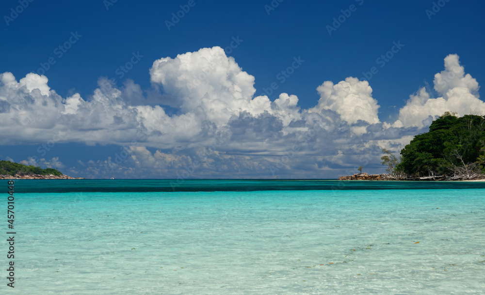 Beautiful beach of Seychelles with a blue and cloudy tropical sky - Curieuse island