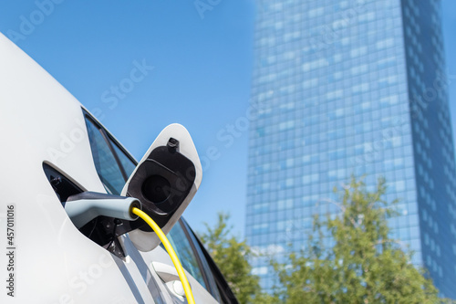 Charging an electric car with power supply cable.