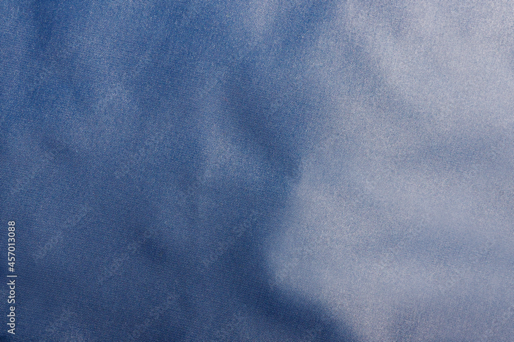 Texture backdrop photo of blue colored and folded bologna fabric. Stock