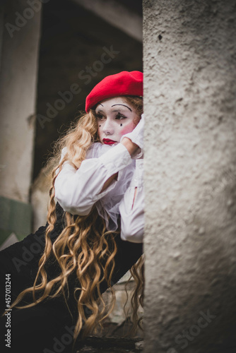 The girl with makeup of the mime. improvisation. Suit for Halloween. mime shows different emotions. Sad clown