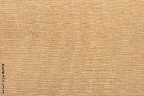 Texture backdrop photo of beige colored corduroy fabric cloth.