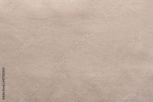 Texture backdrop photo of beige colored denim cloth.