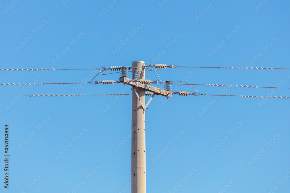 Photograph of a concrete telephone post and cables