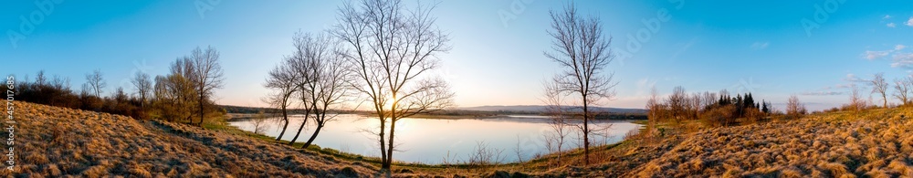 Panorama lake view in sunrise time .Sunrise at the lake Panorama lake view in sunrise time .Sunrise at the lake