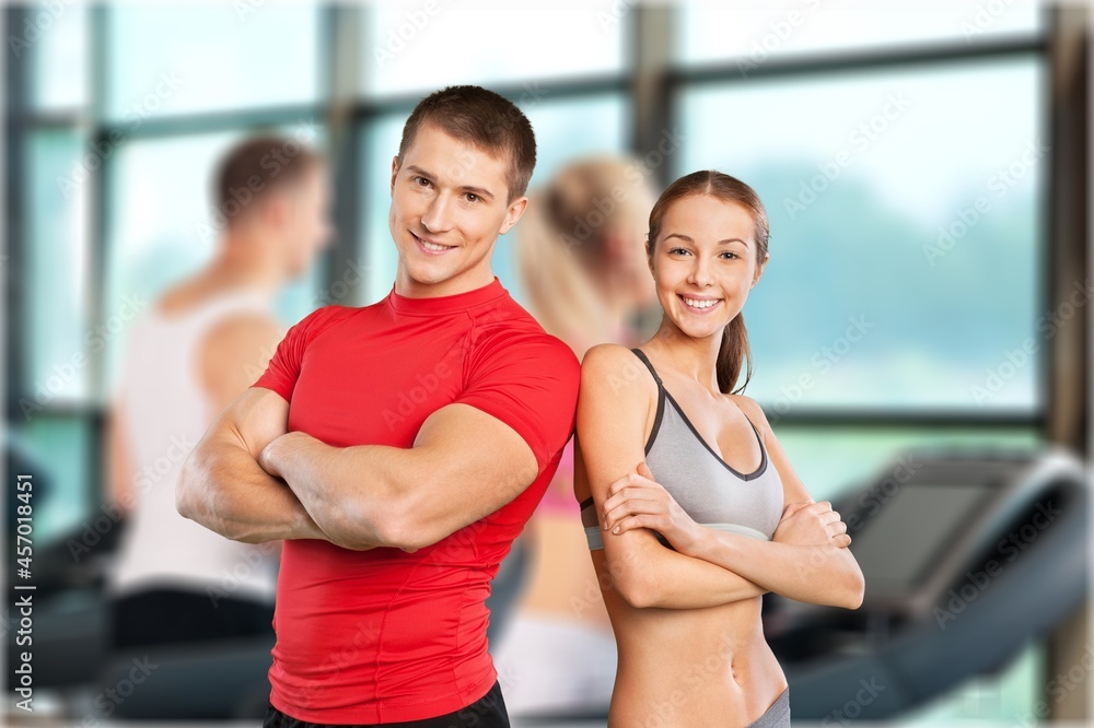 Attractive couple doing training program in the fitness center or gym, Attractive couple doing training program in the fitness center or gym,