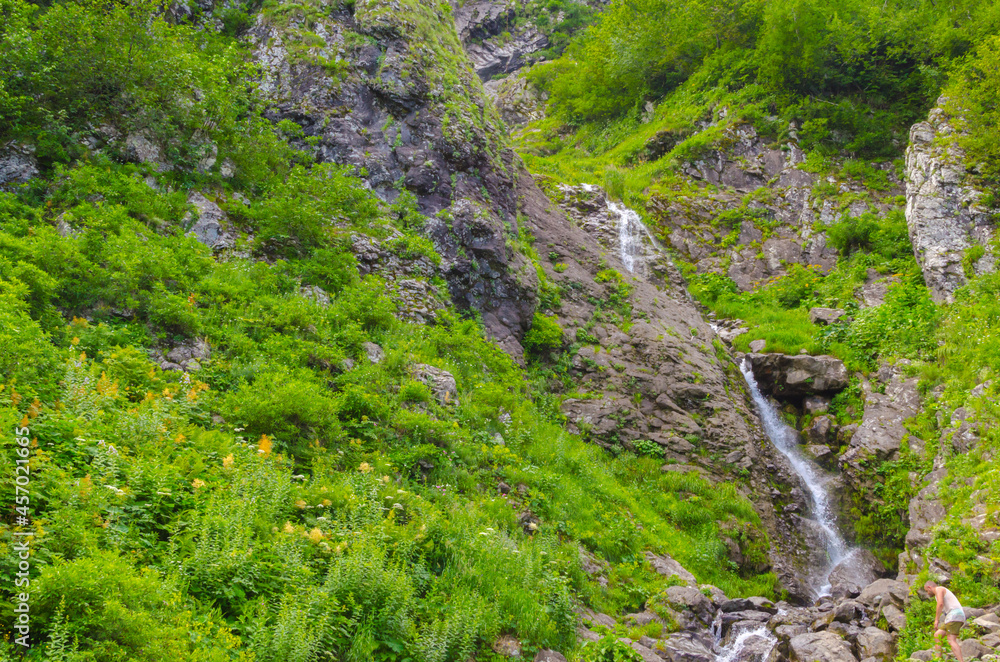 Small waterfall in the mountains in summer
