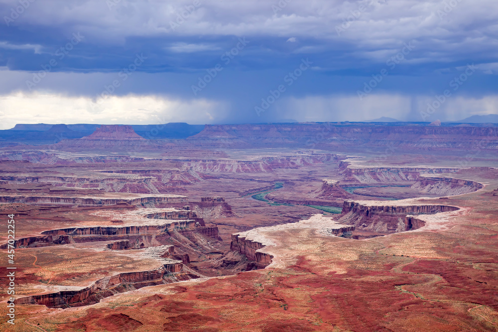 A storm approaches Canyonlands National Park in Utah as the Colorado River slowly cuts deeper into the canyon, as seen from one of the overlooks.