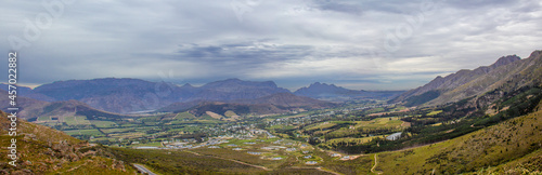 A panoramic view of the town of Franschhoek in Western Cape, South Africa, as seen from the pass through the mountains.