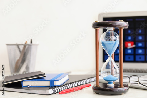 Hourglass and laptop with c...