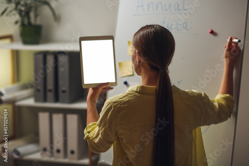Businesswoman holding table...