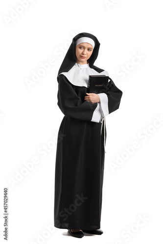 Young nun with Bible on whi...