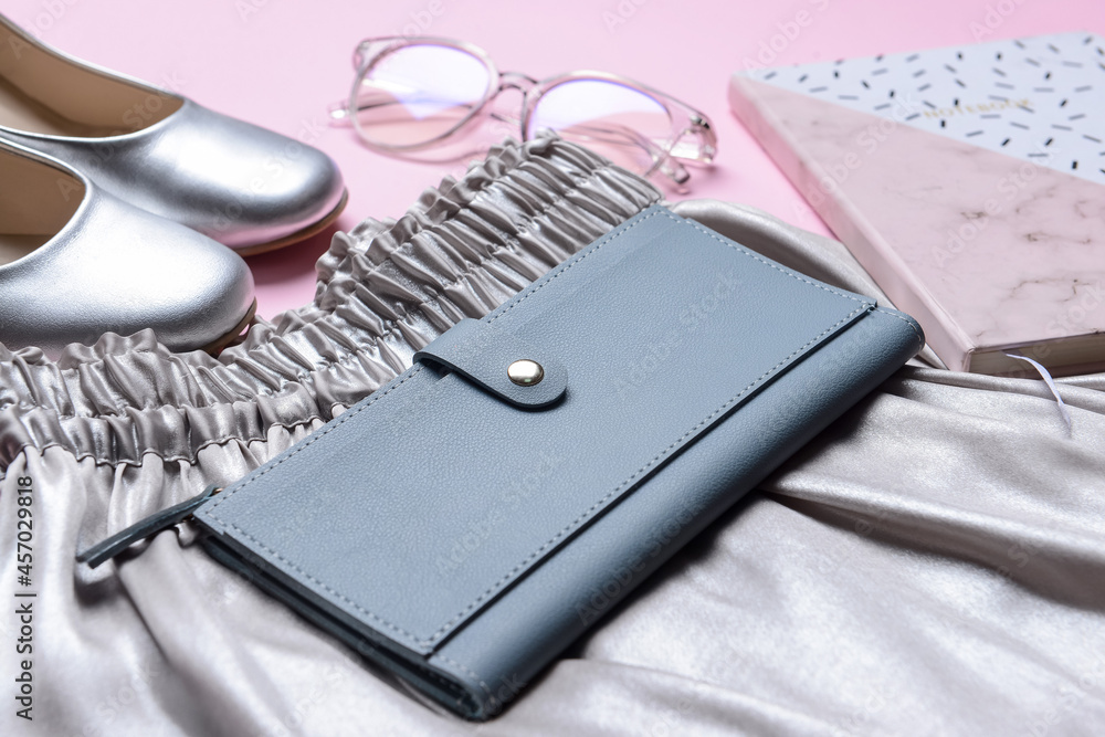 Stylish wallet and female accessories on table, closeup Stylish wallet and female accessories on table, closeup