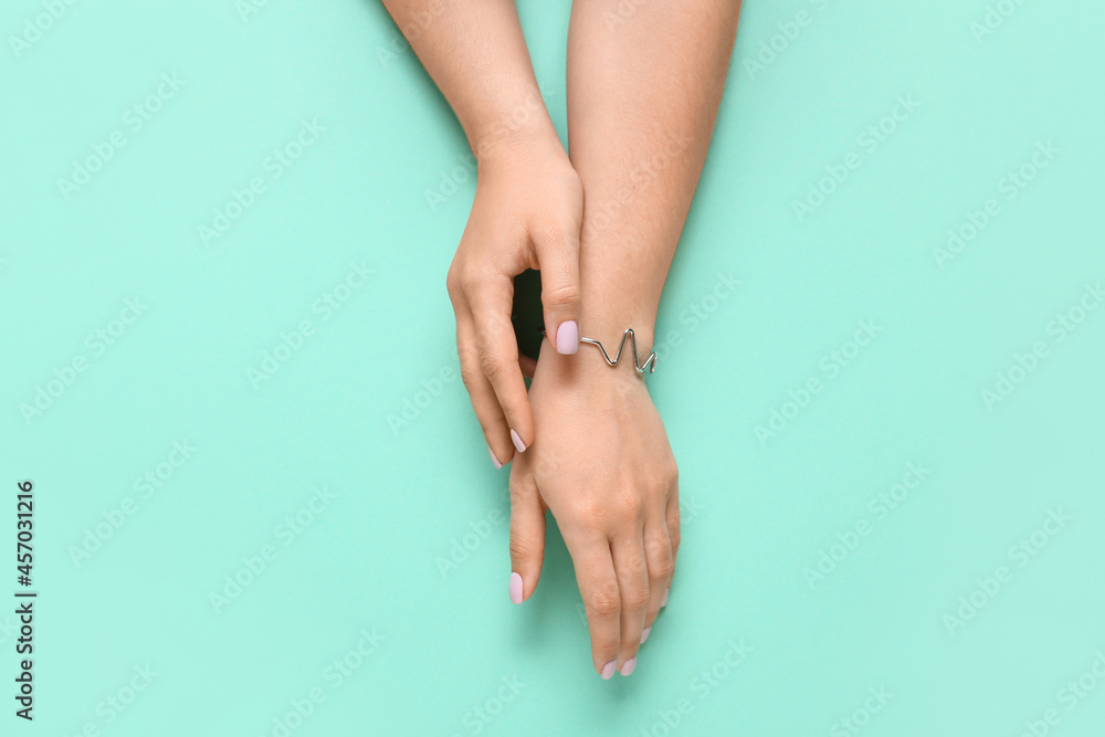 Woman with beautiful manicure and stylish jewelry on color background