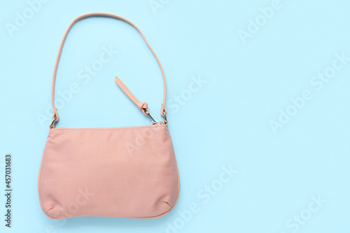 Stylish handbag on blue background