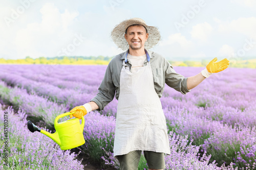 Farmer with watering can in...