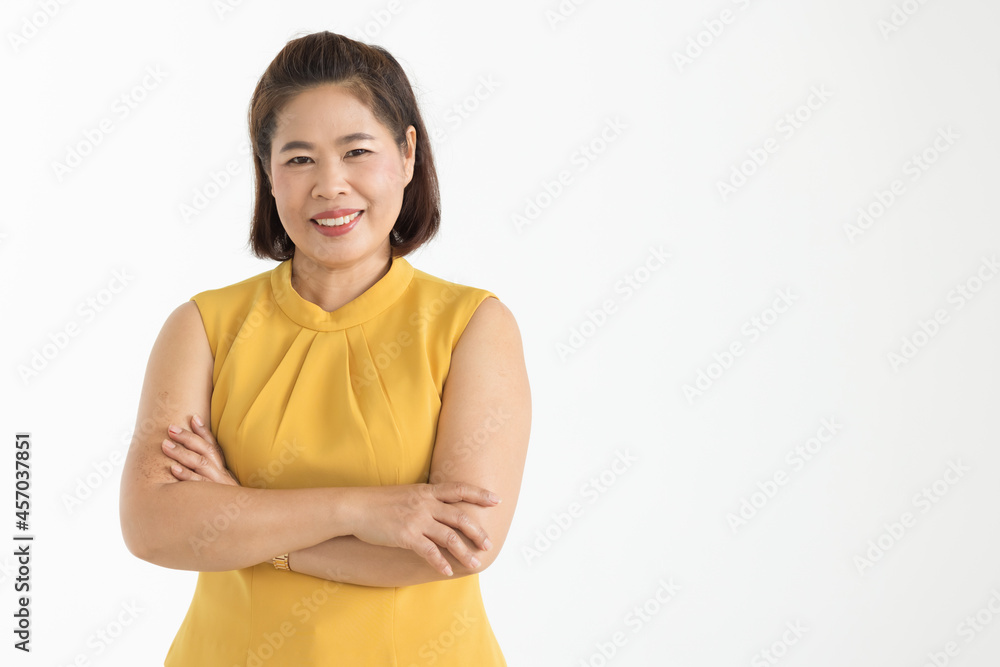 Portrait of middle aged Asian woman wearing yellow blouse smiling beautifully with confident isolated Portrait of middle aged Asian woman wearing yellow blouse smiling beautifully with confident isolated