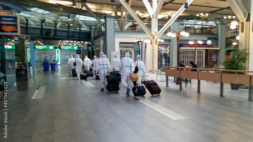 departure of passengers in protective suits at the airport
