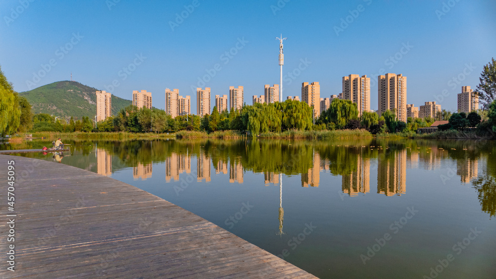 Naklejka premium Urban buildings reflection in water