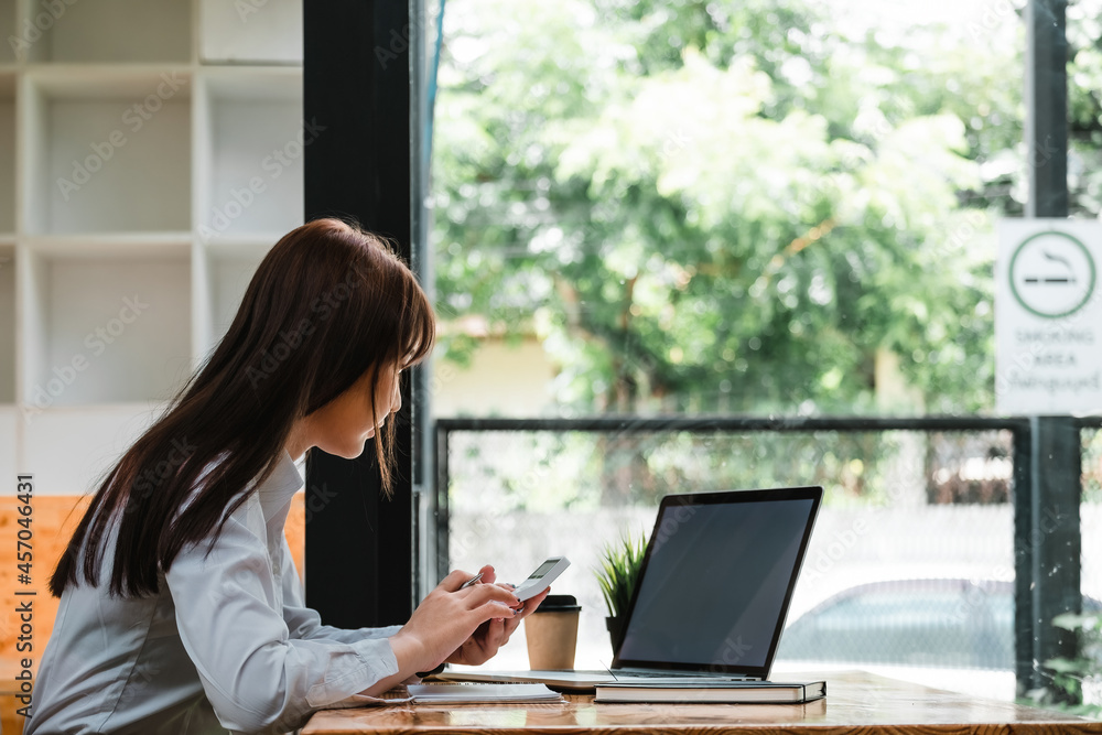 Business accounting concept, Business woman using calculator with computer laptop, budget and loan paper in office Business accounting concept, Business woman using calculator with computer laptop, budget and loan paper in office