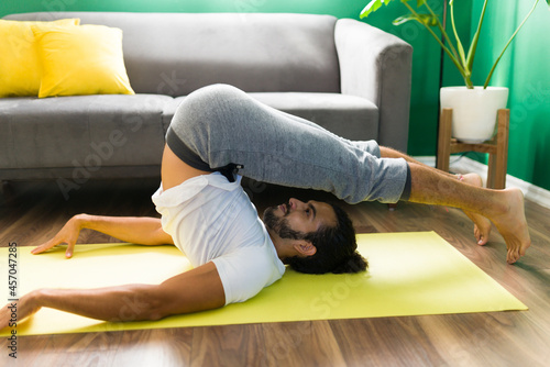 Sporty man exercising with yoga