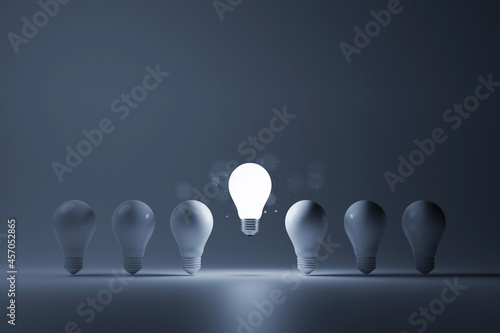 Light bulb bright outstanding among lightbulb on white background. Concept of creative idea and inspire innovation, Think different, Standing out from the crowd. 3d rendering illustration photo