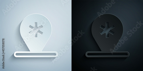 Paper cut Medical map pointer with cross hospital icon isolated on grey and black background. Paper art style. Vector