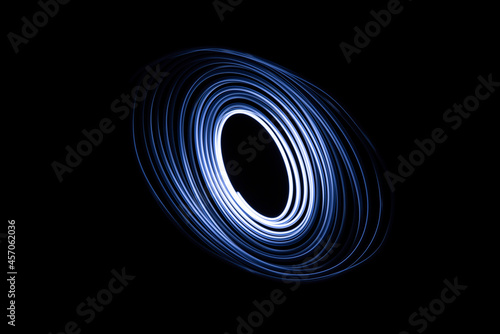Long exposure of a tiny light swirling over the camera