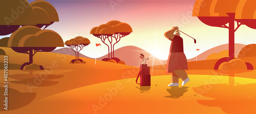 senior woman playing golf on sunny golf course aged player taking a shot active old age concept